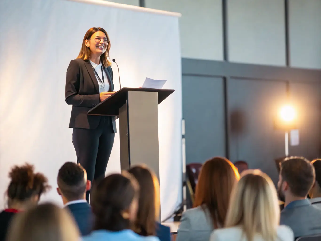A captivating image of a speaker presenting at a LES ZAZOUS cultural conference, with attendees actively engaged in the discussion.